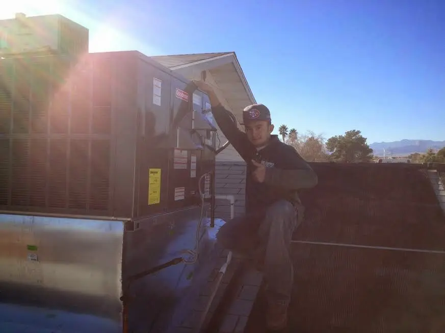 HVAC technician performing HVAC Inspection on a rooftop unit in North College Hill